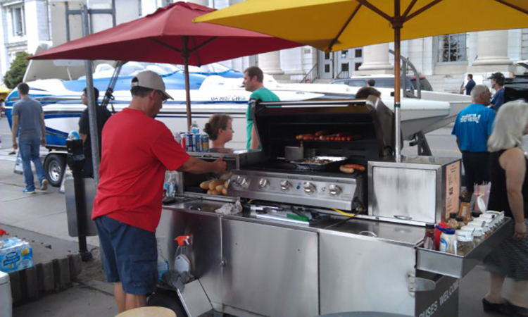 Grilling hot dogs at 1000 Islands Poker Run